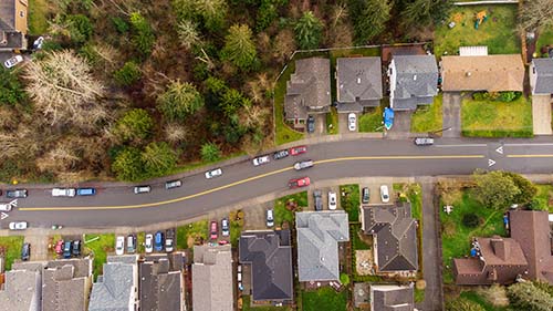 CANUE | Pathways Between Transportation and Health - February 4th | 2022Aerial view of residential neighborhood surrounded by trees. A s