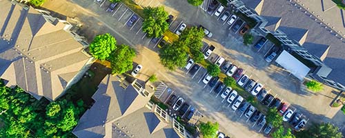 CANUE | Predicting Environmental and Social Impacts for Smart Sustainable Cities |September 18 | 2018Panorama aerial view of apartment garage with full of covered pa