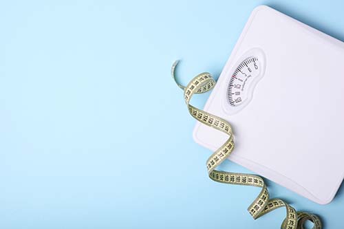 CANUE | Environments and Health Signature Initiative Webinar: Obesity and Environment | March 27, 2023 | 12:30 p.m. - 2:00 p.m. (ET)floor scales and tape measure on a colored background top view.